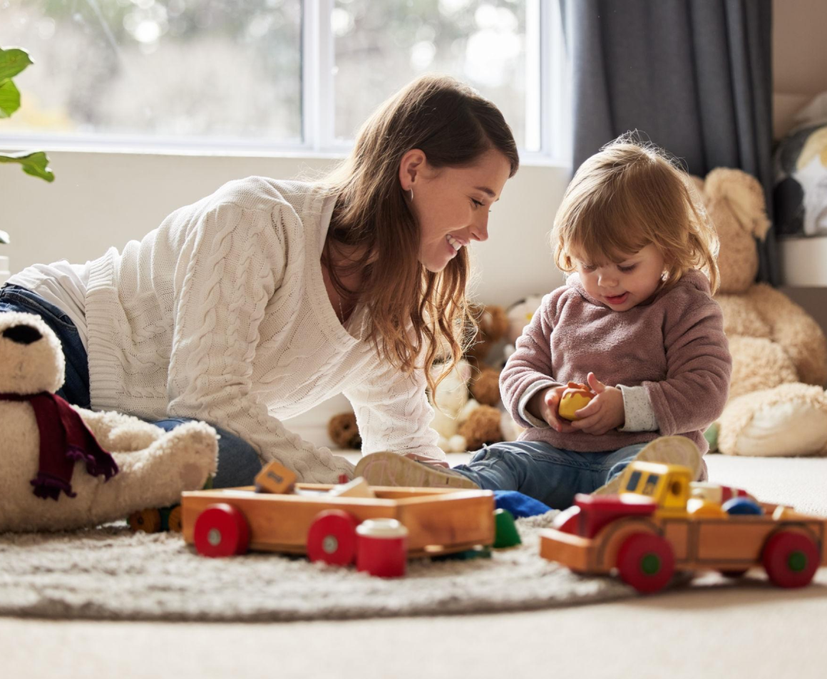 Mother and child playing with toys indoors.