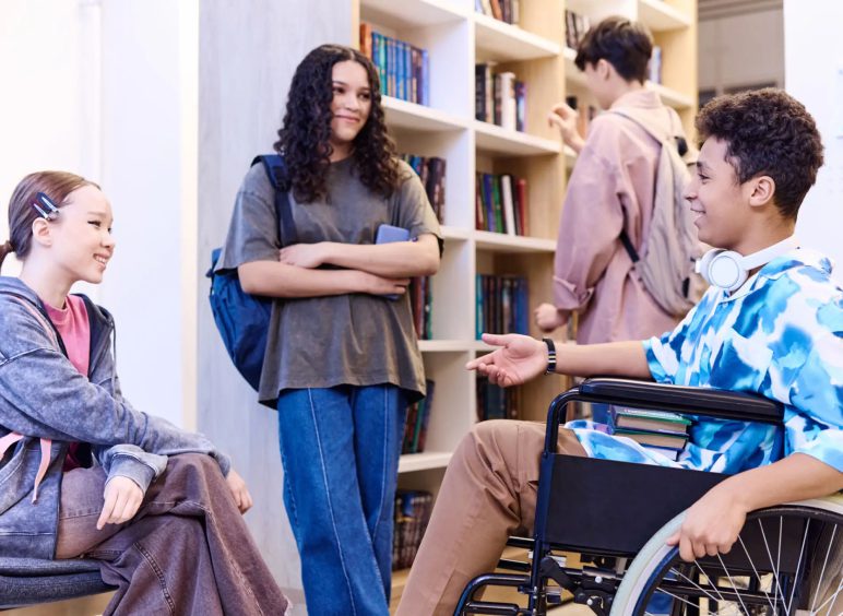 Students talking and studying in a library.